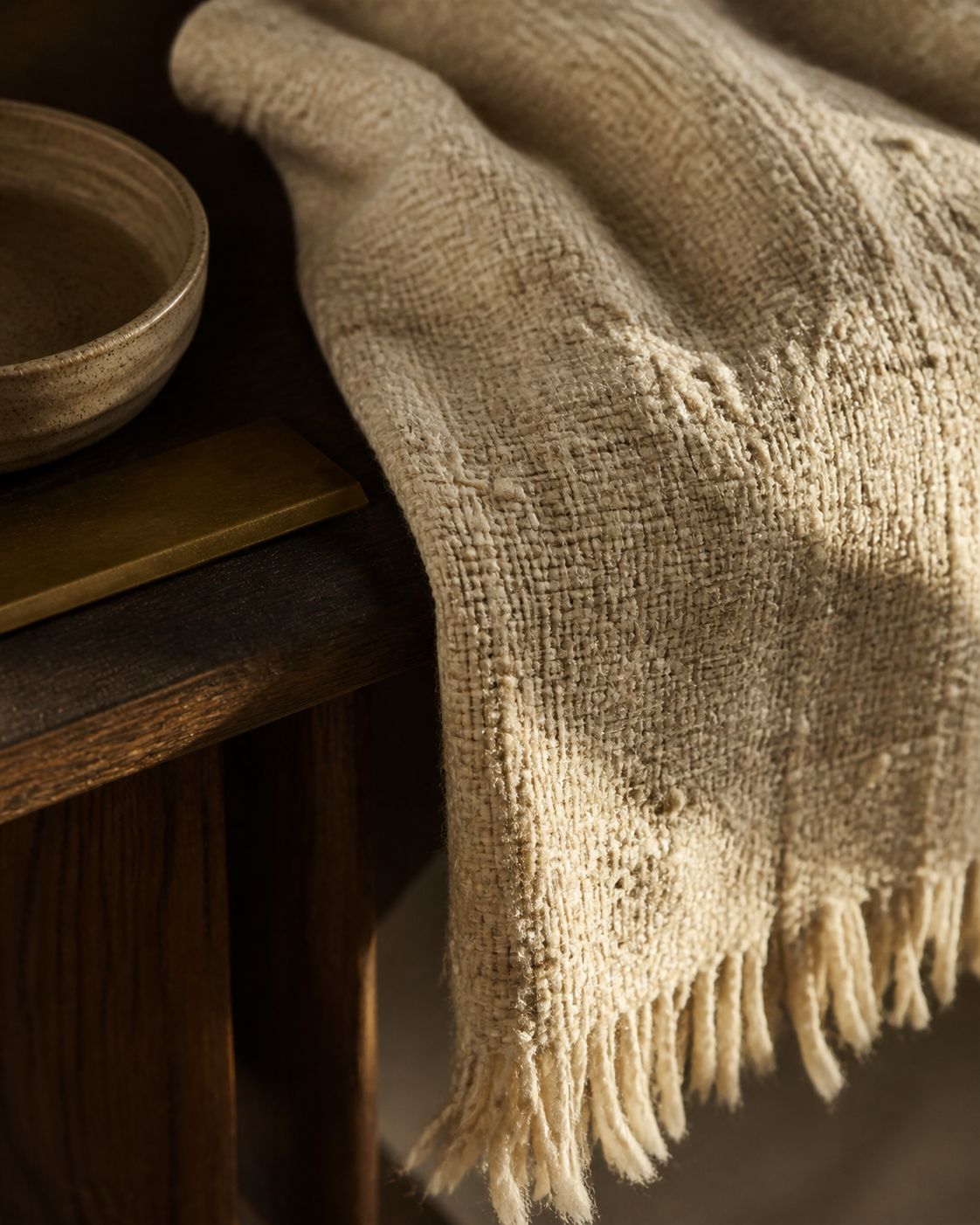 Hand-woven throw resting over an oak console